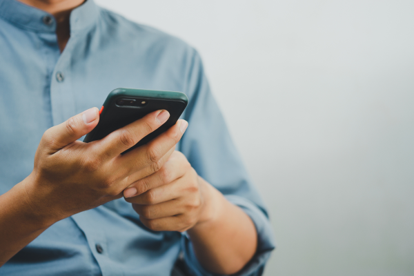 Man on his mobile phone avoiding crypto scam apps